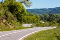 Asphalted road with curves and unevenness in the countryside