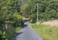 Asphalted road in the forest where the pilgrims walk in the Camino de Santiago, Galicia, Spain. Royalty Free Stock Photo