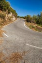 Asphalted serpentine mountain road at sunset