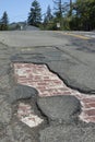 An asphault street gives way to the original brick road that lay underneath. Royalty Free Stock Photo