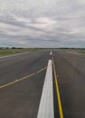 Asphlat airport runway with signs for plane arrival and departure Royalty Free Stock Photo