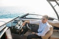 Aspirational successful businessman standing by luxury boats and yachts against a deep blue sky, holding his jacket over Royalty Free Stock Photo