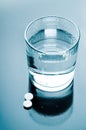 Aspirin pills and glass of water Royalty Free Stock Photo