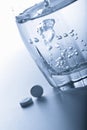 Aspirin pills and glass of water Royalty Free Stock Photo