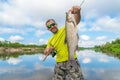 Aspius fishing. Happy fisherman with asp fish at beautifle river Royalty Free Stock Photo