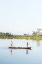 Assam, india - August 12, 2020 : Boatman with a beautiful landscape at the of golden hour.