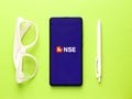 Assam, india - August 27, 2020 : NSE logo on phone screen stock image.