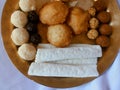 Assamese traditional food items like pitha, laddu, doi sira with assamese gamosa background