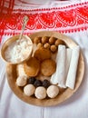 Assamese traditional food items like pitha, laddu, doi sira with assamese gamosa background