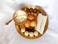 Assamese traditional food items like pitha, laddu, doi sira with assamese gamosa background