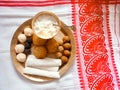 Assamese traditional food items like pitha, laddu, doi sira with assamese gamosa background