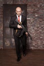 Assassin in suit and red tie holding machine gun Royalty Free Stock Photo