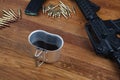 assault rifle and cup of coffee on wooden table Royalty Free Stock Photo