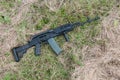 Assault rifle in the grass.
