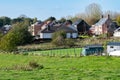 Asse, Flemish Brabant Region, Belgium - Scenic view over green hills and meadows ith residential houses in the background