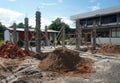 Steel binding and pole entry on construction site with a pile of sand and a pile of bricks. Royalty Free Stock Photo