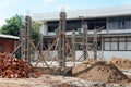 Steel binding and pole entry on construction site with a pile of sand and a pile of bricks. Royalty Free Stock Photo