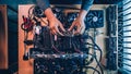 Hands assembling a blockchain mining rig with hardware components