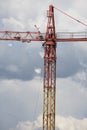 Assembling of crane on dramatic cloudy background. Dangerous height situation. Royalty Free Stock Photo