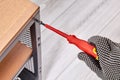 Assembling of flat pack furniture by worker who uses screwdriver Royalty Free Stock Photo