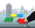 Assembling four puzzles on table Royalty Free Stock Photo