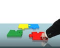 Assembling four puzzles on table Royalty Free Stock Photo