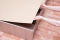 Assembling furniture. The Caucasian girl holds wooden flooring for slatted bottom of the bed