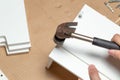 Assembling of furniture, closeup of hammer in hand