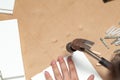 Assembling of furniture, closeup of hammer in hand