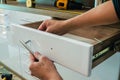 Assembling furniture, installing furniture decorative handles on the furniture facade Royalty Free Stock Photo