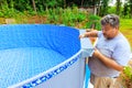 Assembling of ground swimming pool near house in back yard as part of a construction process Royalty Free Stock Photo