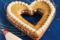 Assembling a heart-shaped cake using butter cream