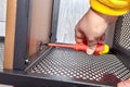 Assembler is mounting metal flat pack furniture using screwdriver Royalty Free Stock Photo