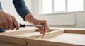 Assembling modern furniture with a hex wrench for a DIY home improvement project Royalty Free Stock Photo