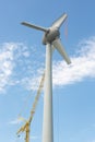 Assembling wings Dutch windturbine with large crane Royalty Free Stock Photo