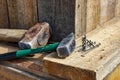 Assembling the wooden formwork of the foundation. Sledgehammer, hammer and self-tapping screws on the wooden formwork of the Royalty Free Stock Photo