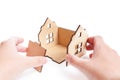 Assembling a wooden house kit on white Royalty Free Stock Photo