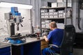 Assembly engineer working on some small equipment at his desk