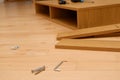 Assembly of furniture, the different parts and pieces of furniture arranged on the wooden floor. DIY furniture assembly concept Royalty Free Stock Photo