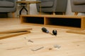 Assembly of furniture, the different parts and pieces of furniture arranged on the wooden floor. DIY furniture assembly concept Royalty Free Stock Photo