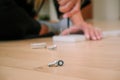 Assembly of furniture, the different parts and pieces of furniture arranged on the wooden floor. A lot of bolts and screws Royalty Free Stock Photo