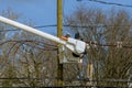 assembly and installation of new support and wires of a power line electricians repairing wire on electric power pole