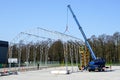 Assembly of the metal frame of the storage hangar with the help of a boom crane and a scissor lift