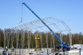 Assembly of the metal frame of the storage hangar with the help of a boom crane and a scissor lift