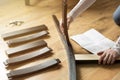 Assembly of wooden furniture, a woman putting together the wooden parts of the dining chair, using instruction. and a furniture s Royalty Free Stock Photo