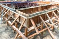 Assembly the wooden molds for pouring concrete foundation of a house. The steel and rod for concrete slap and pole Royalty Free Stock Photo