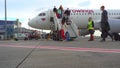 assengers are traveling. Arrival at the airport. Flight. Eurowings plane. Many people in masks and with suitcases travel