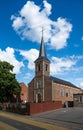 Assent, Limburg, Belgium - Church tower and street in the center of the village