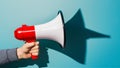 Assertive communication hand holds megaphone casting sharp shadow Royalty Free Stock Photo