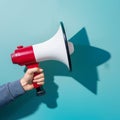 Assertive communication hand holds megaphone casting sharp shadow Royalty Free Stock Photo